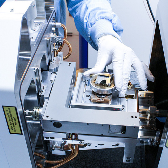Scanning Electron Microscope (SEM) hand in laboratory glove at Scanning Electron Microscope (SEM)